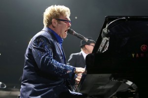 Elton John performing at the piano