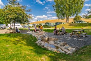 Children paddling and exploring the stepping-stone stream next to the picnic area.